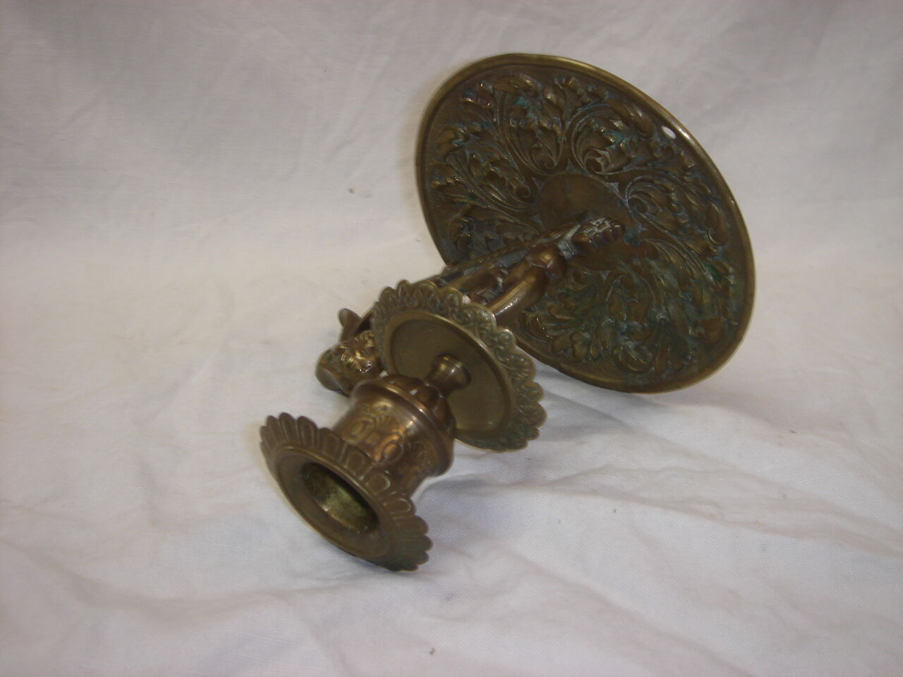 Ancient candlestick in carved bronze ram