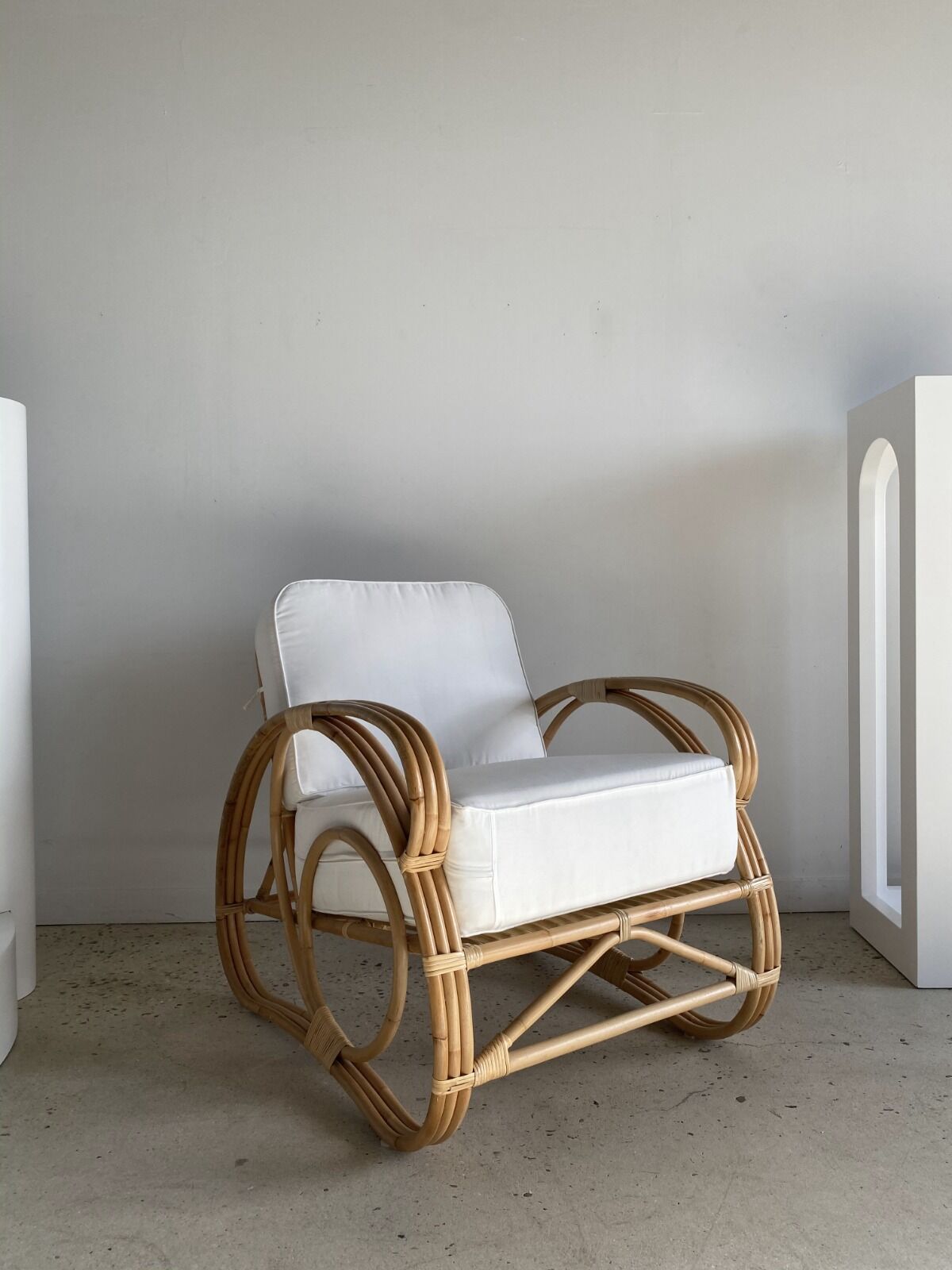 Large rattan rest chair and white cushions