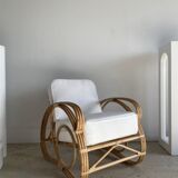 Large rattan rest chair and white cushions