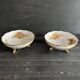 Pair of tripod bowls in gilded Limoges porcelain.