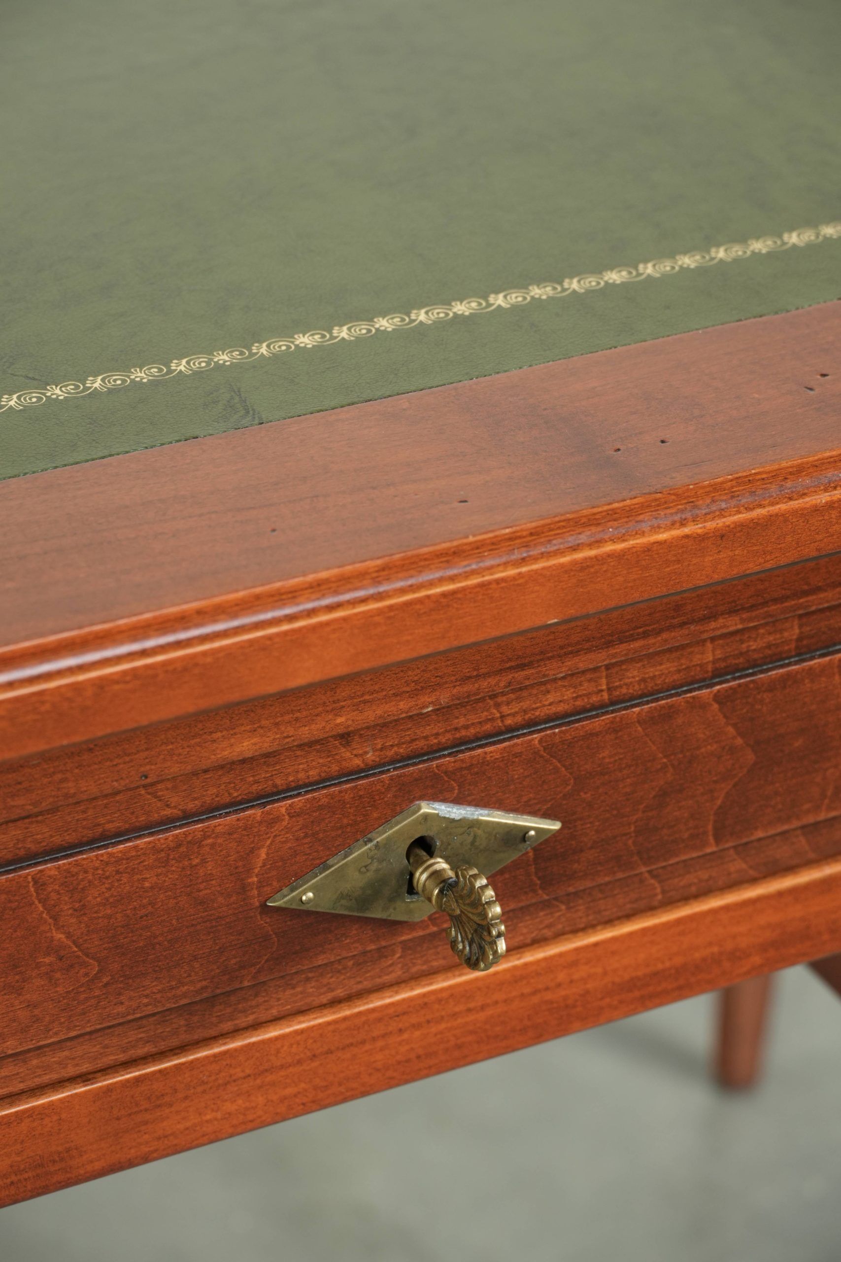 Elegant English style desk with green leather top, gold details and drawers
