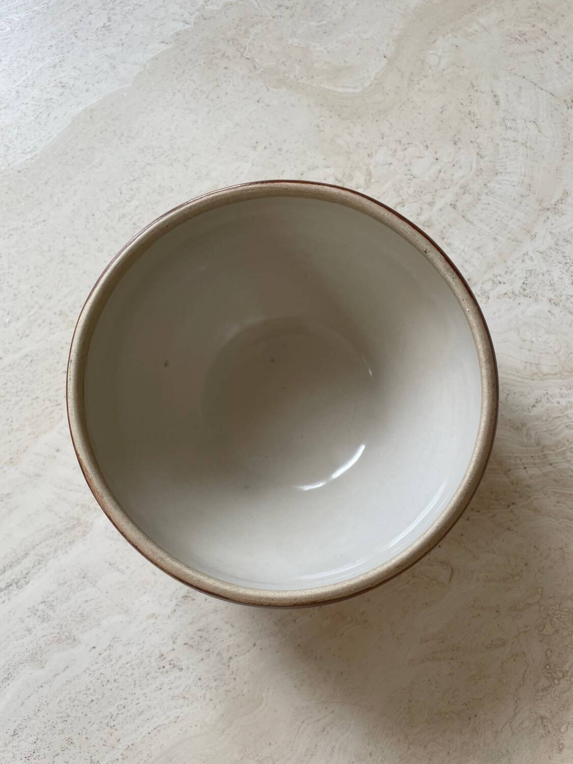 Old stoneware bowl with brown edge
