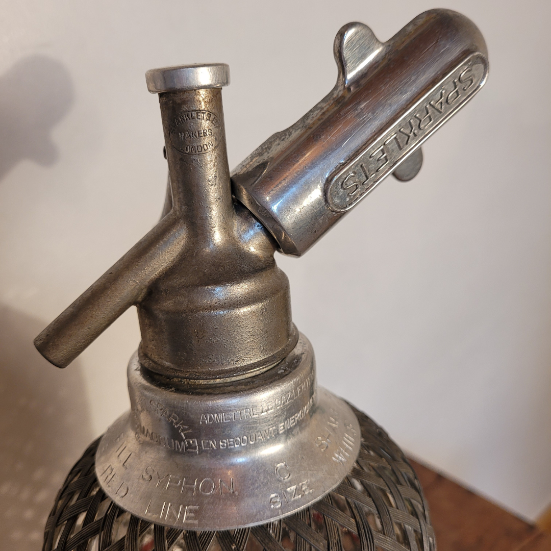 Old glass and metal siphon