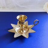 Golden brass hand candle holder decorated with leaves