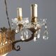 Antique chandelier in gilded bronze with neoclassical decorations from the 19th century.