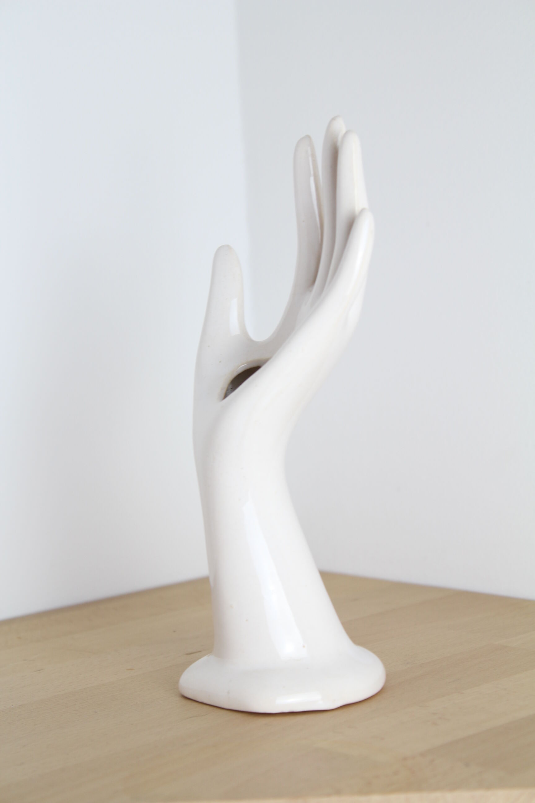 White hand ceramic ring sizer doilies