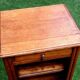 Golden oak bedside table topped with a moulded shelf niche with a shelf from the 1930s.