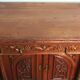 Art Nouveau buffet in carved oak with grapevine cluster decoration.
