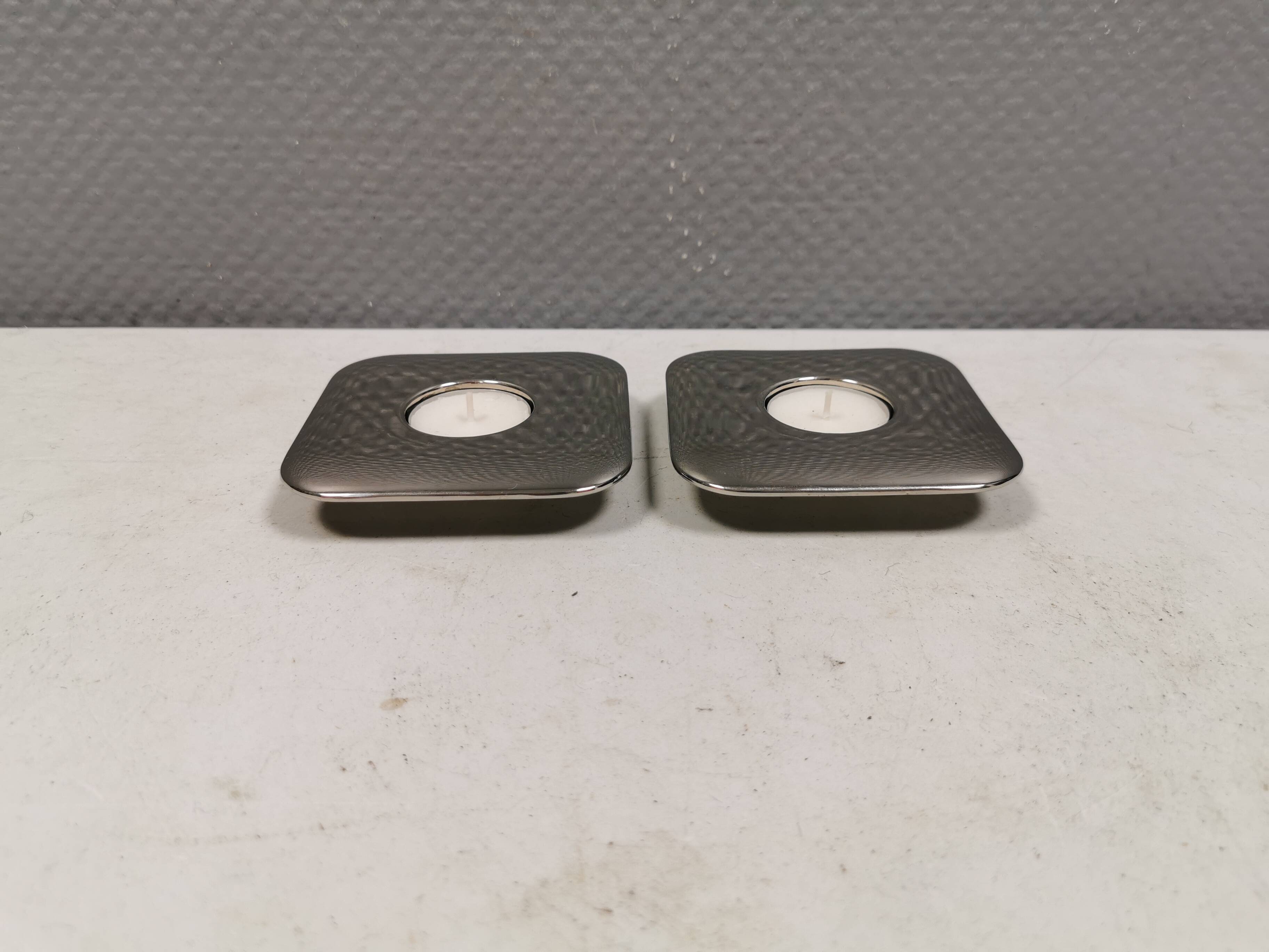 A set of classic Danish candlesticks in polished metal.