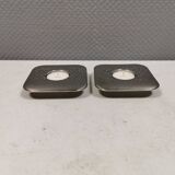 A set of classic Danish candlesticks in polished metal.