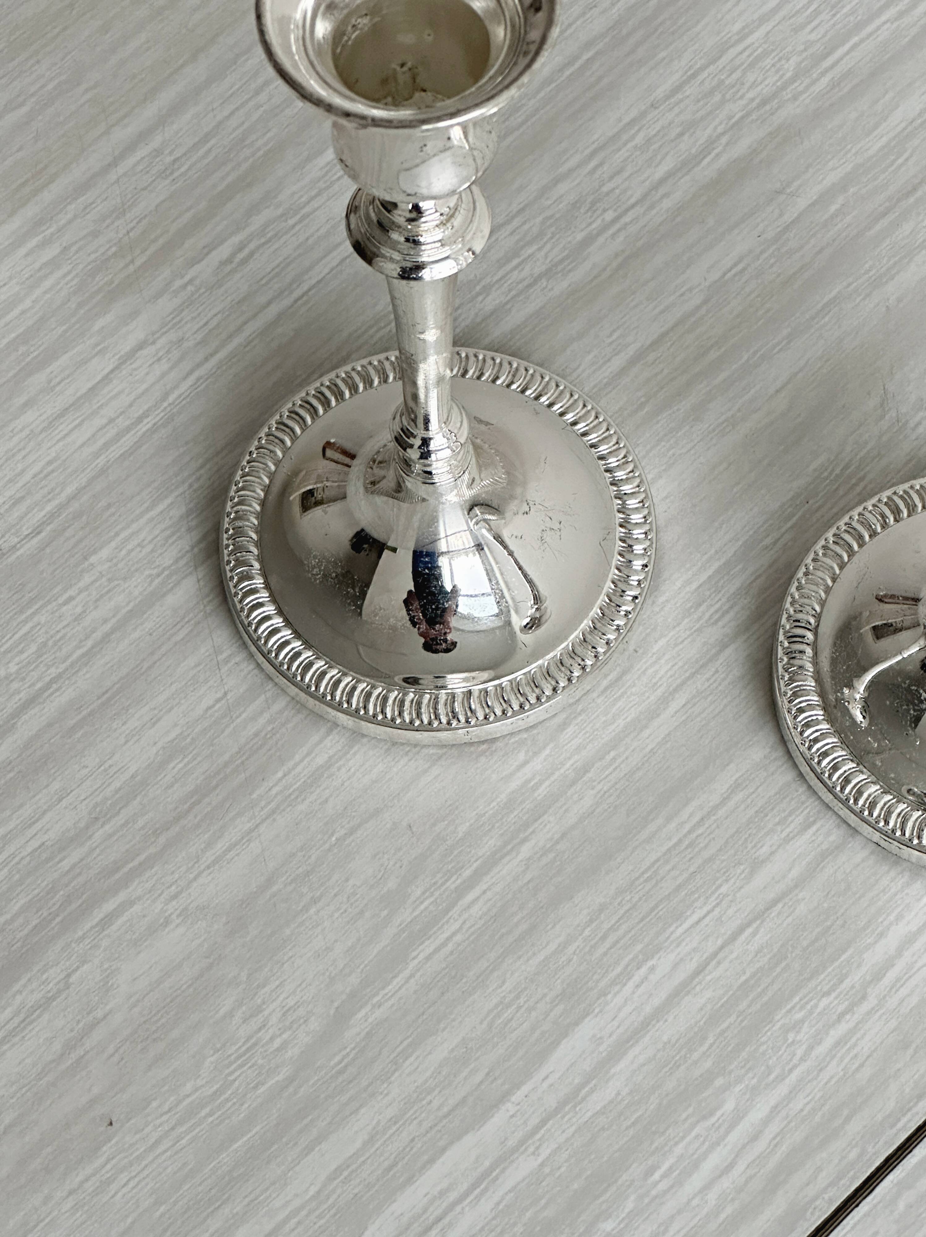 Pair of white metal candlesticks