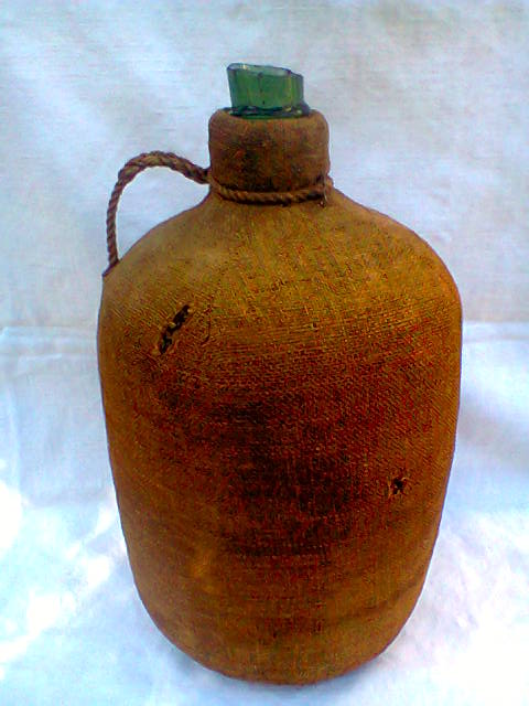 Demijohn dressed in burlap and padded cork
