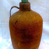 Demijohn dressed in burlap and padded cork