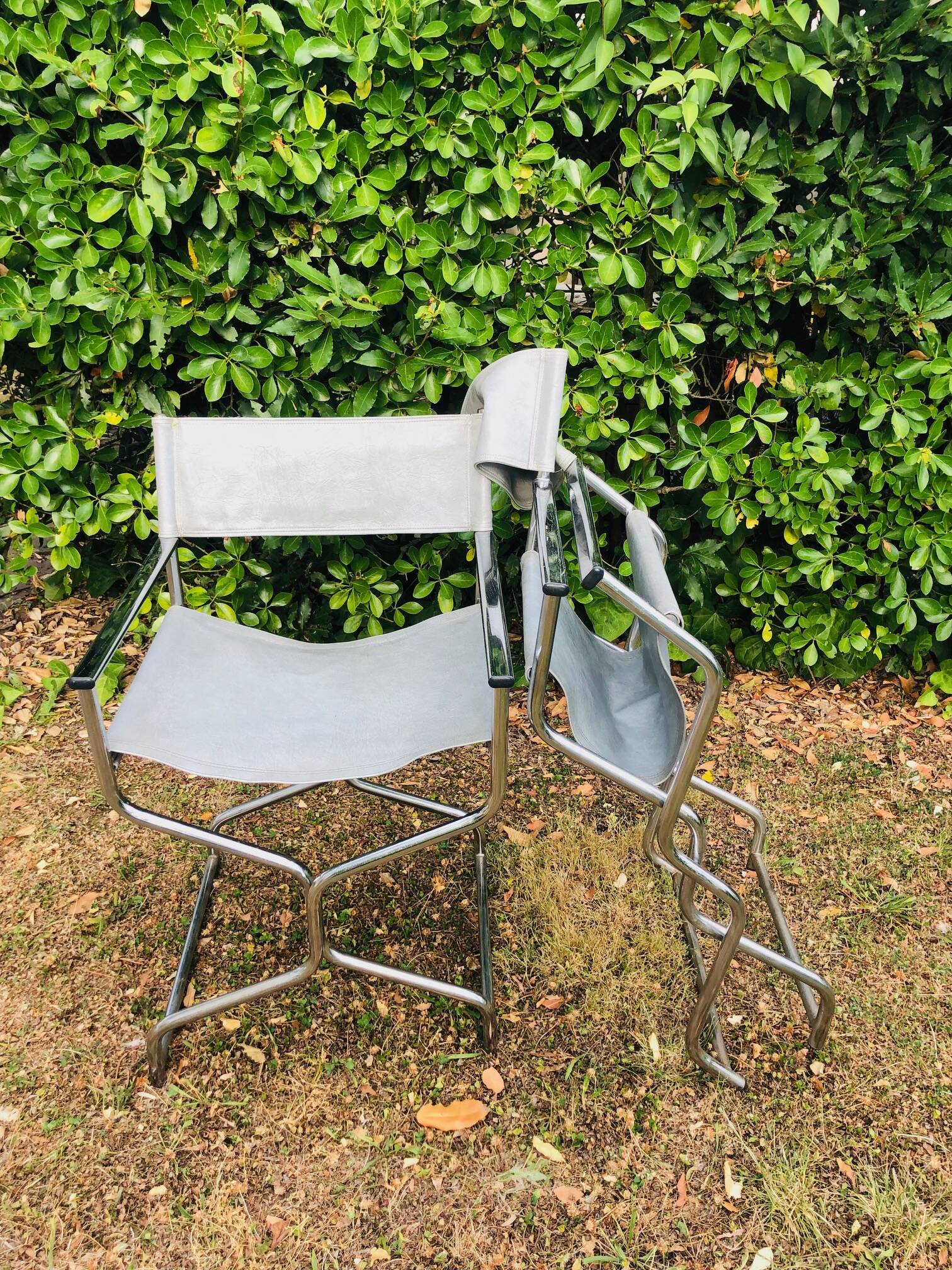 Pair of folding metal and leather armchairs