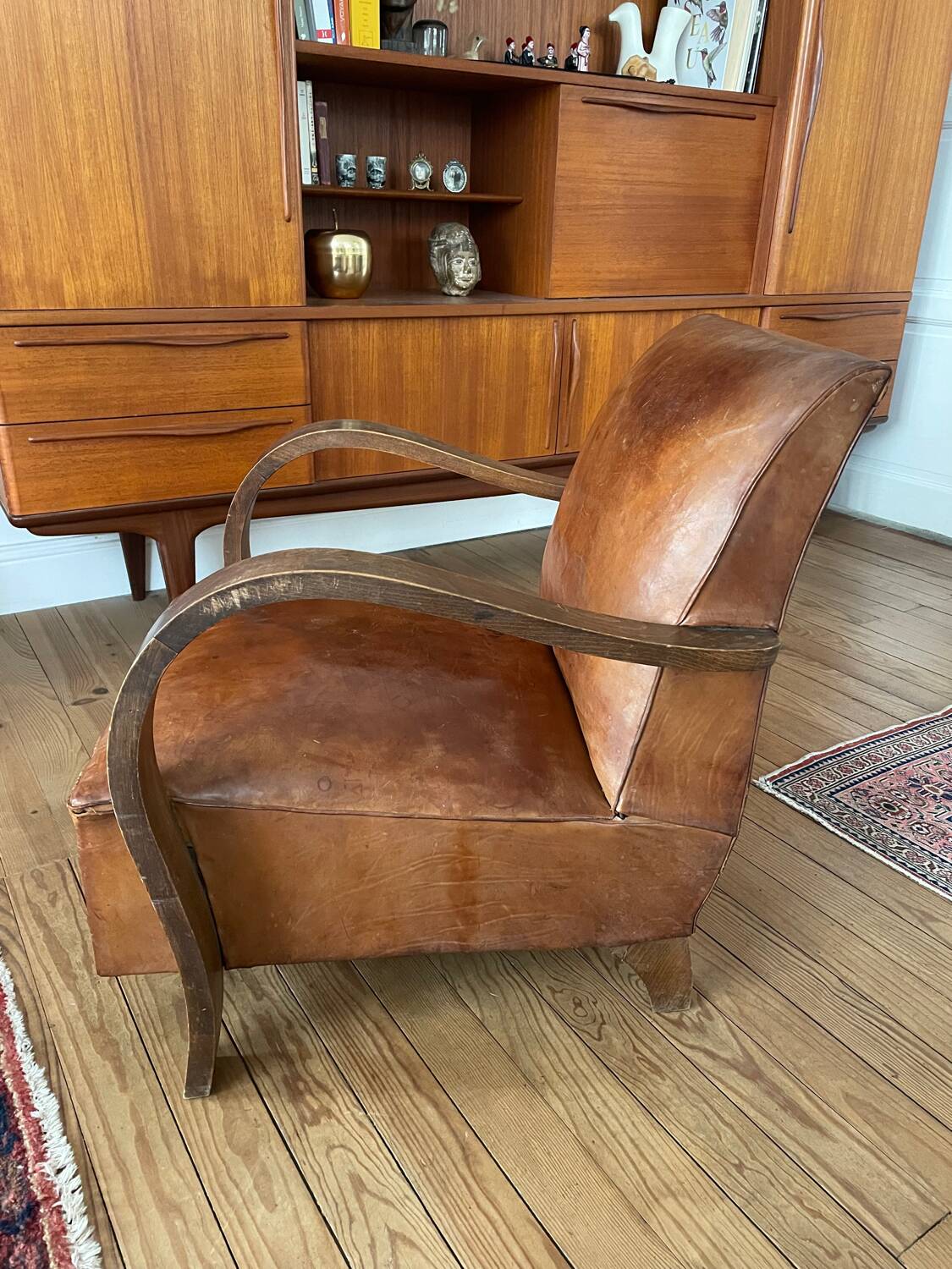 Vintage leather club chair with wooden armrests