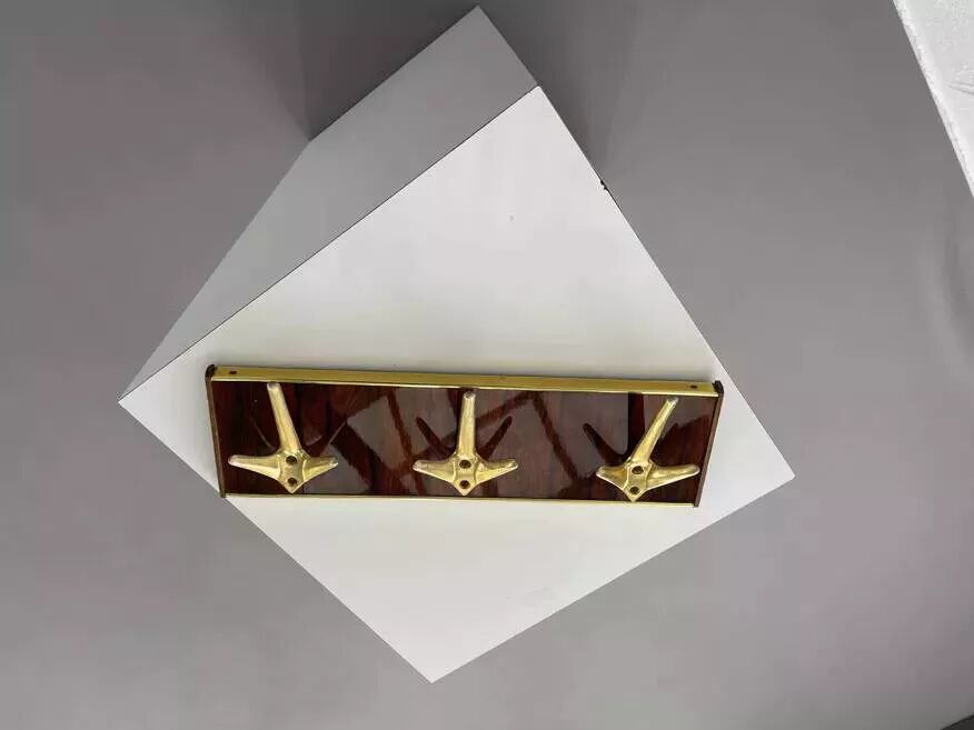 Coat rack or wall hook from the 1950s in wood and brass.