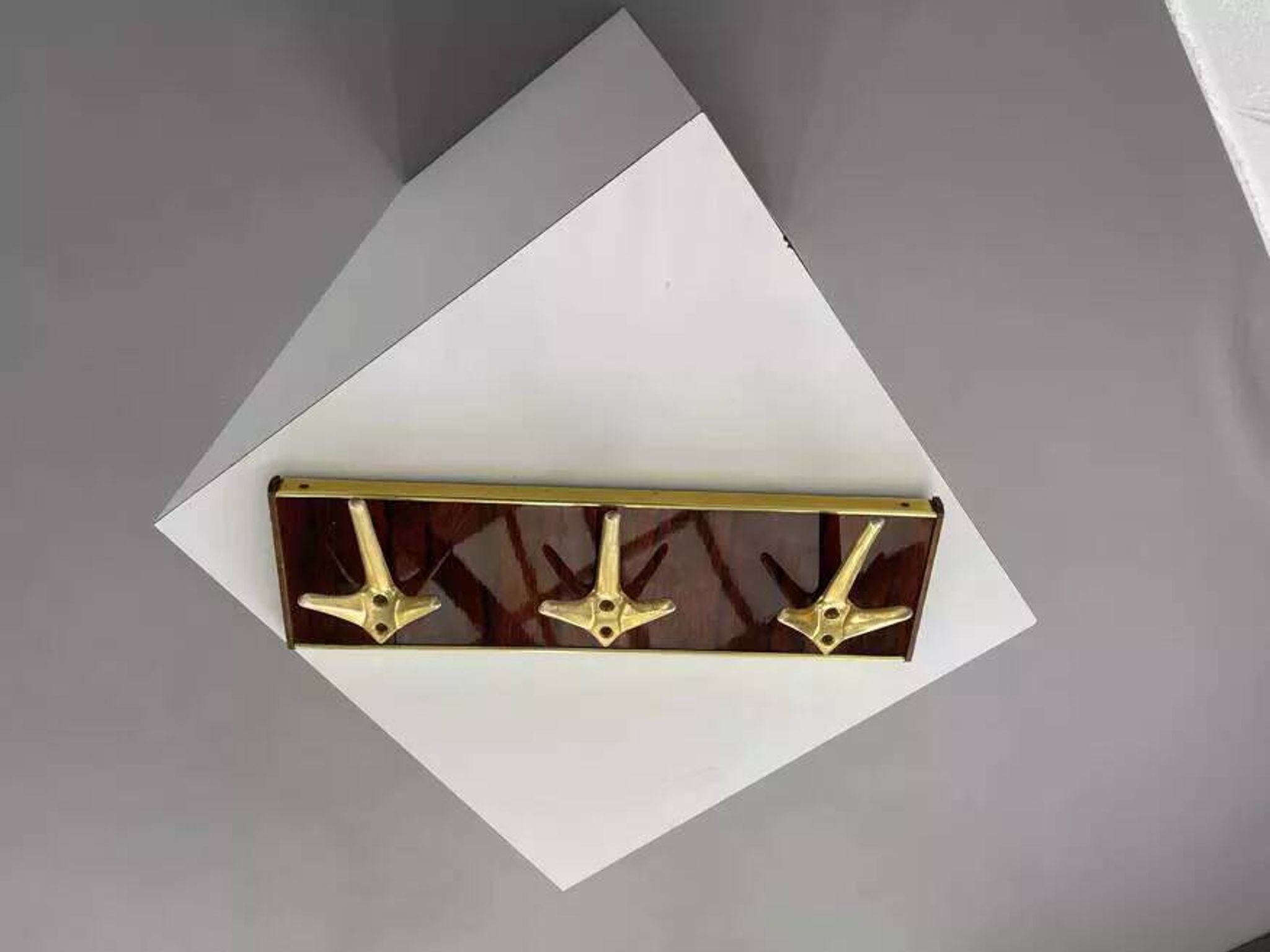 Coat rack or wall hook from the 1950s in wood and brass.