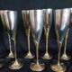 Lot of 12 silver metal flutes on brass stand