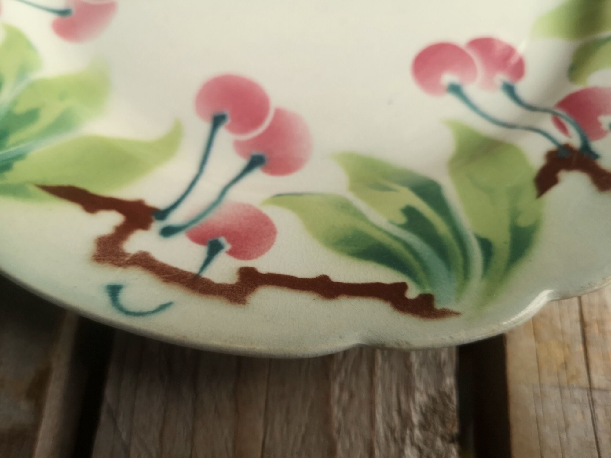 Old decorative plate in barbotine by luneville cherry motif
