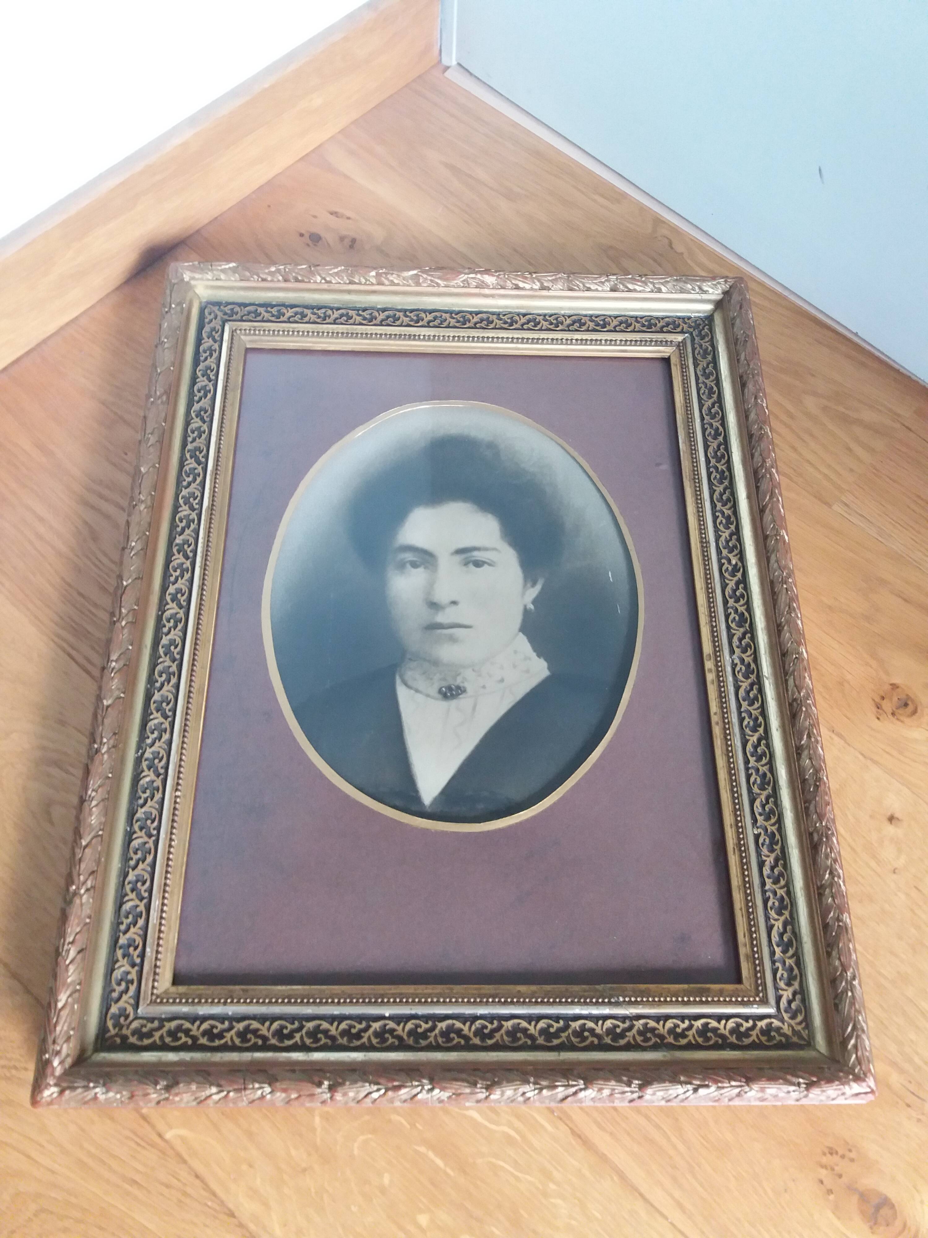 Old photo portrait framed in wood and stucco
