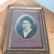 Old photo portrait framed in wood and stucco