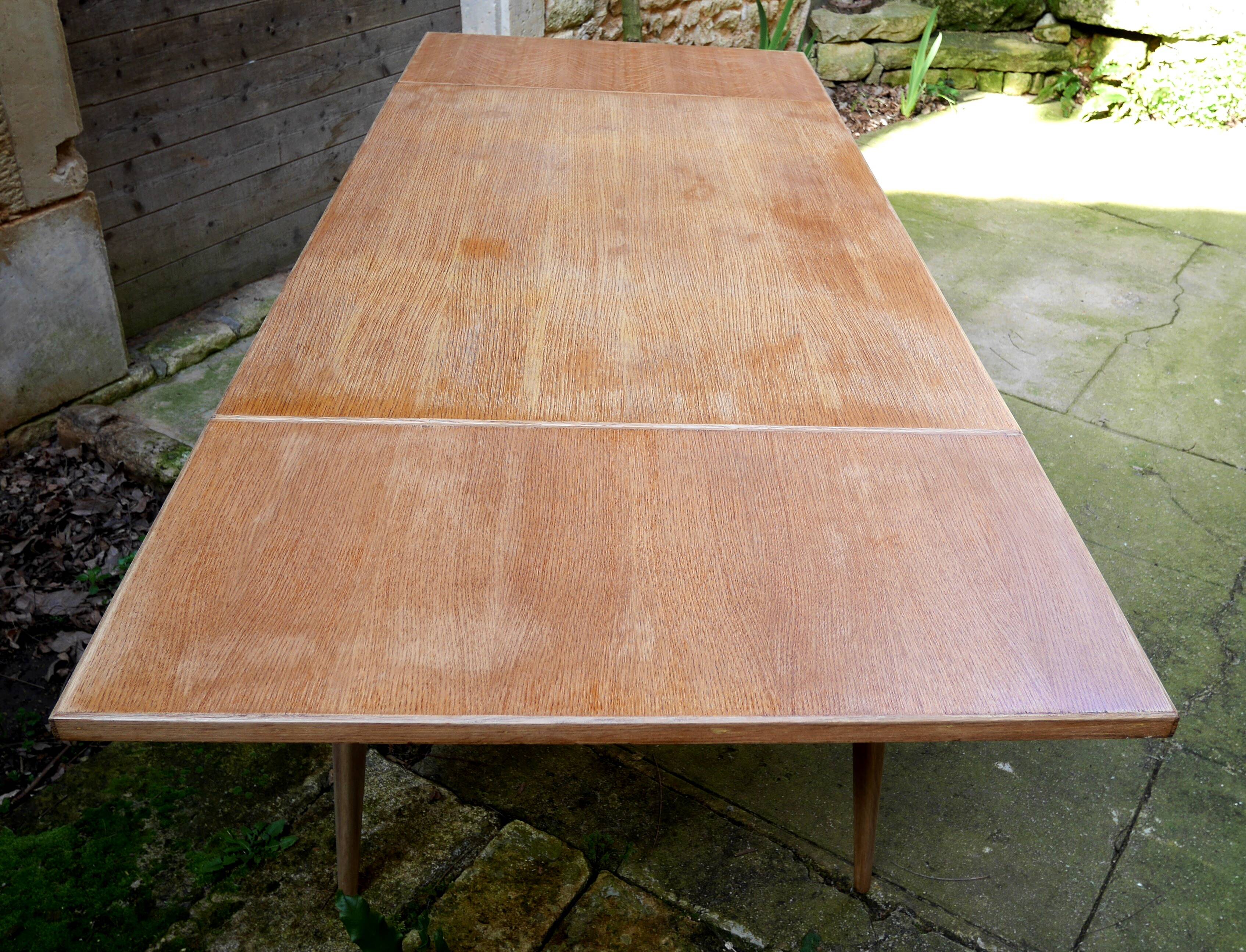wooden dining table with compass legs and extensions