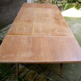 wooden dining table with compass legs and extensions