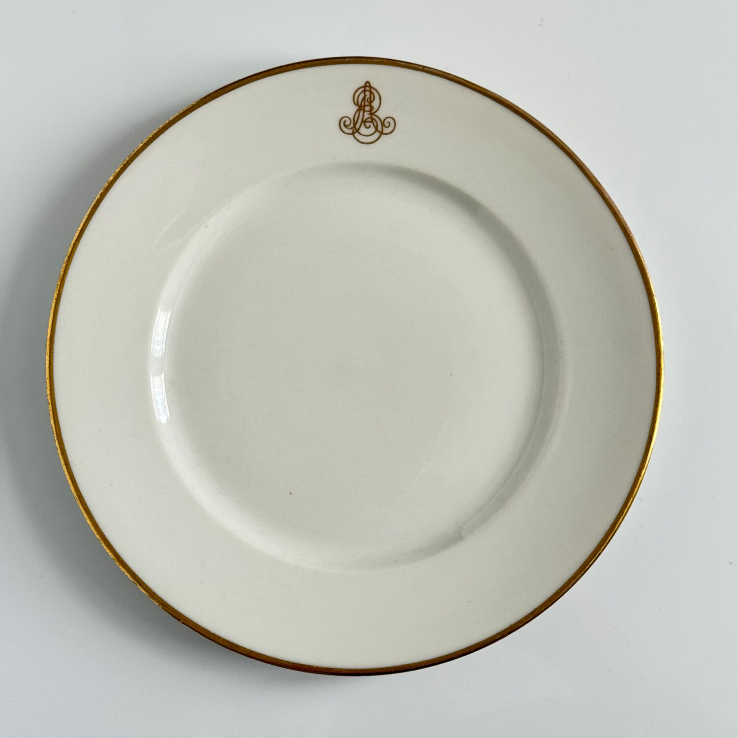 Set of monogrammed plates with gilt edges | E. Bourgeois | Late 19th century