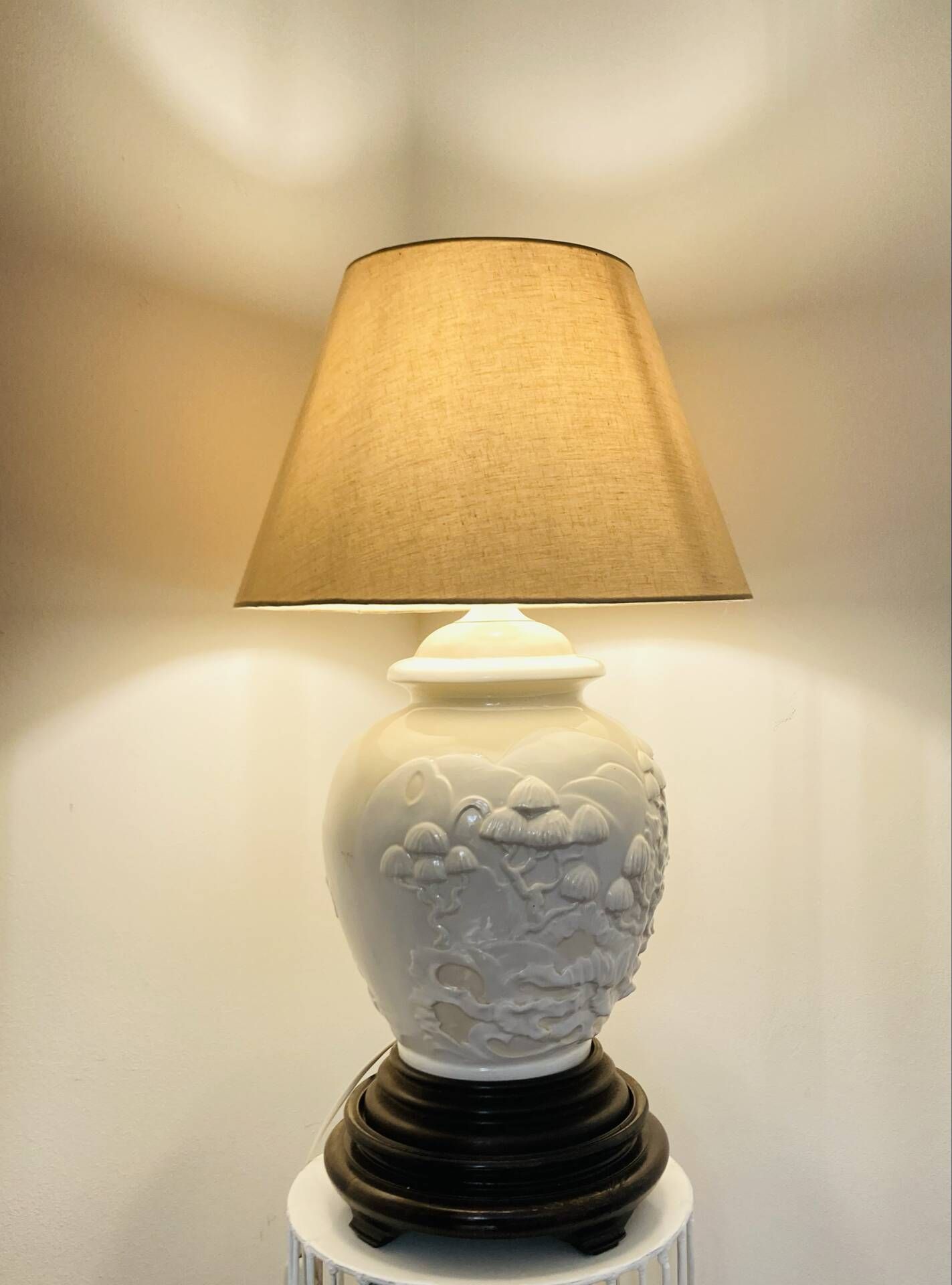 1980s ceramic table lamp with a wooden base and adjustable shade.