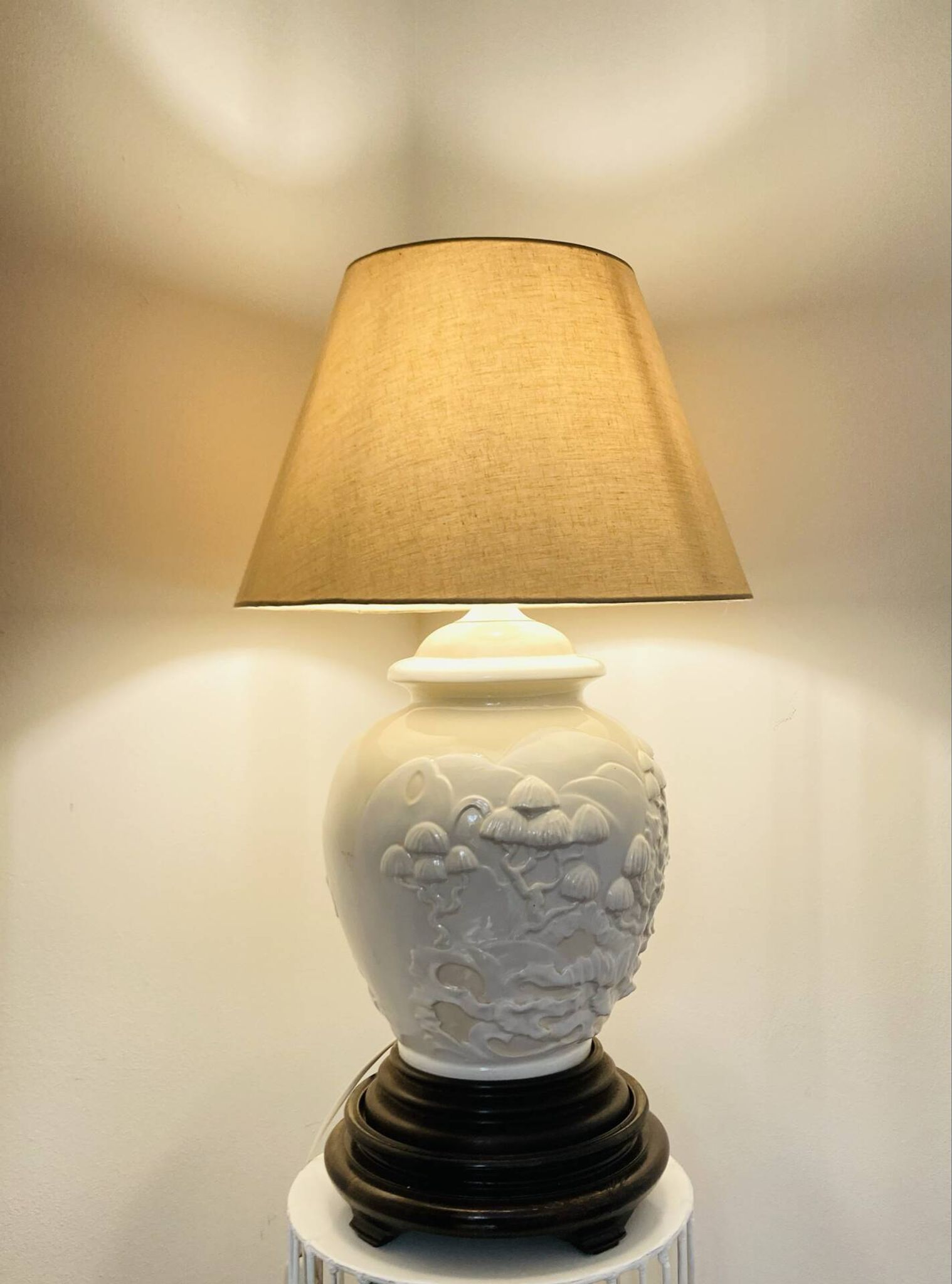 1980s ceramic table lamp with a wooden base and adjustable shade.