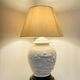 1980s ceramic table lamp with a wooden base and adjustable shade.