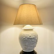 1980s ceramic table lamp with a wooden base and adjustable shade.
