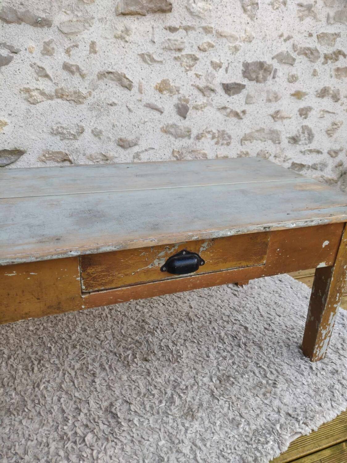 Patinated coffee table with a drawer