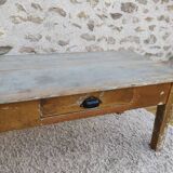 Patinated coffee table with a drawer