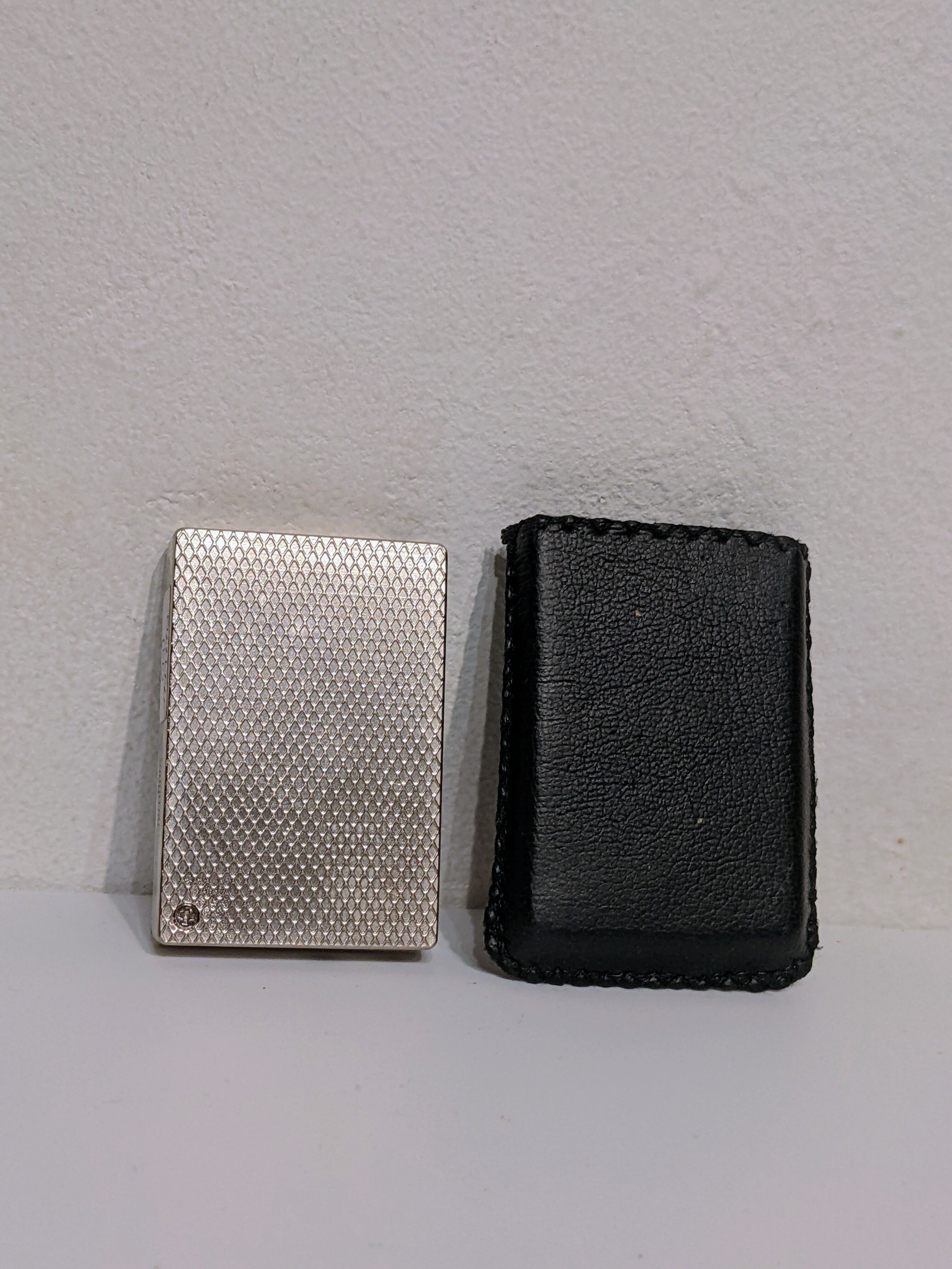 Old lighter new picoflam new condition in its small pocket leather case some stains on the et