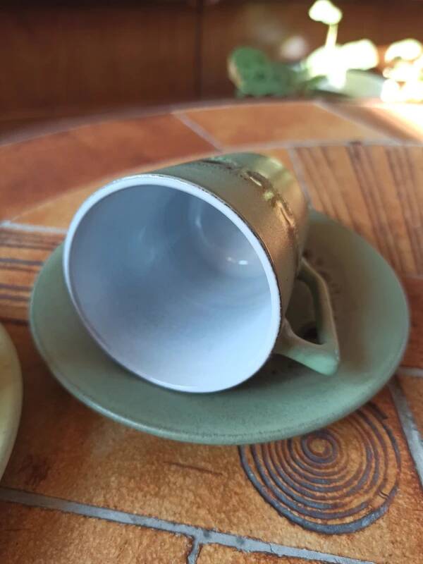 A pair of vintage glazed stoneware cups and saucers.