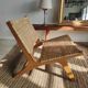 Reclining armchair in natural wood and woven rattan