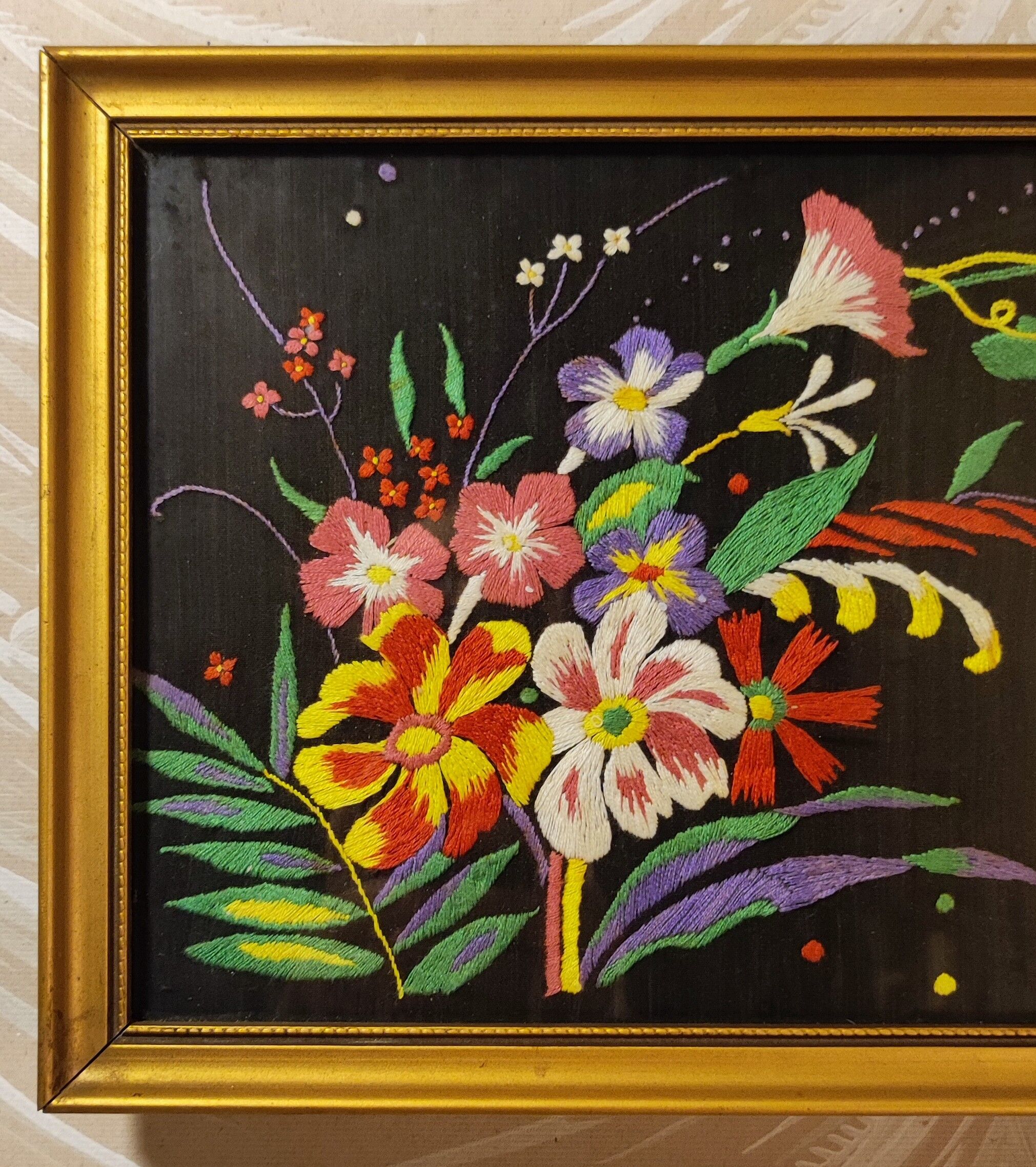 Floral embroidery on black silk framed 1950
