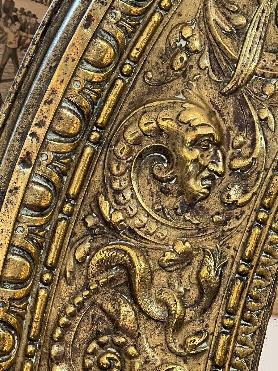 A. Arens, Antwerp, important oval mirror in repoussé brass with numerous animal decorations
