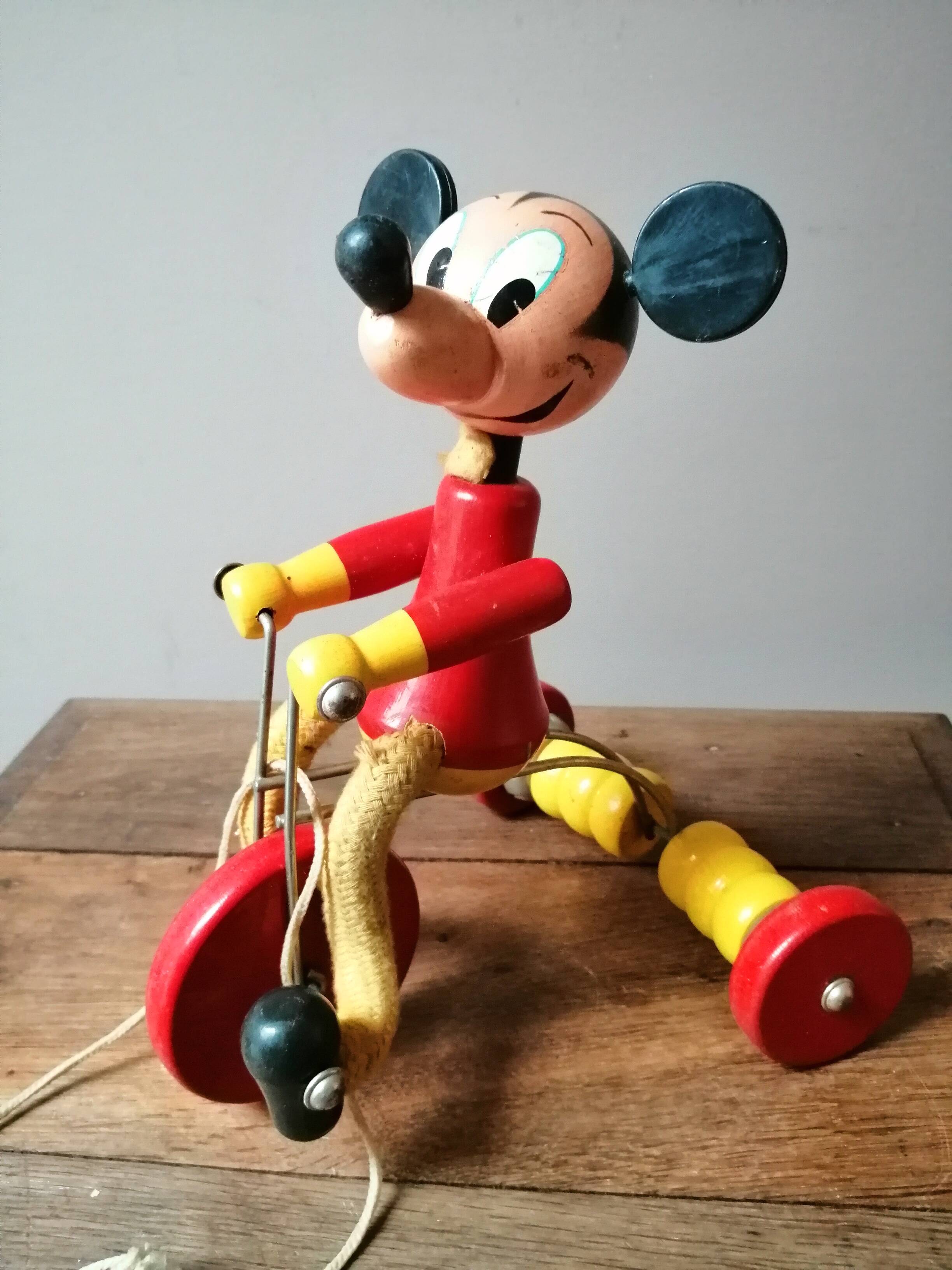 Old Mickey Mouse toy on his wooden tricycle