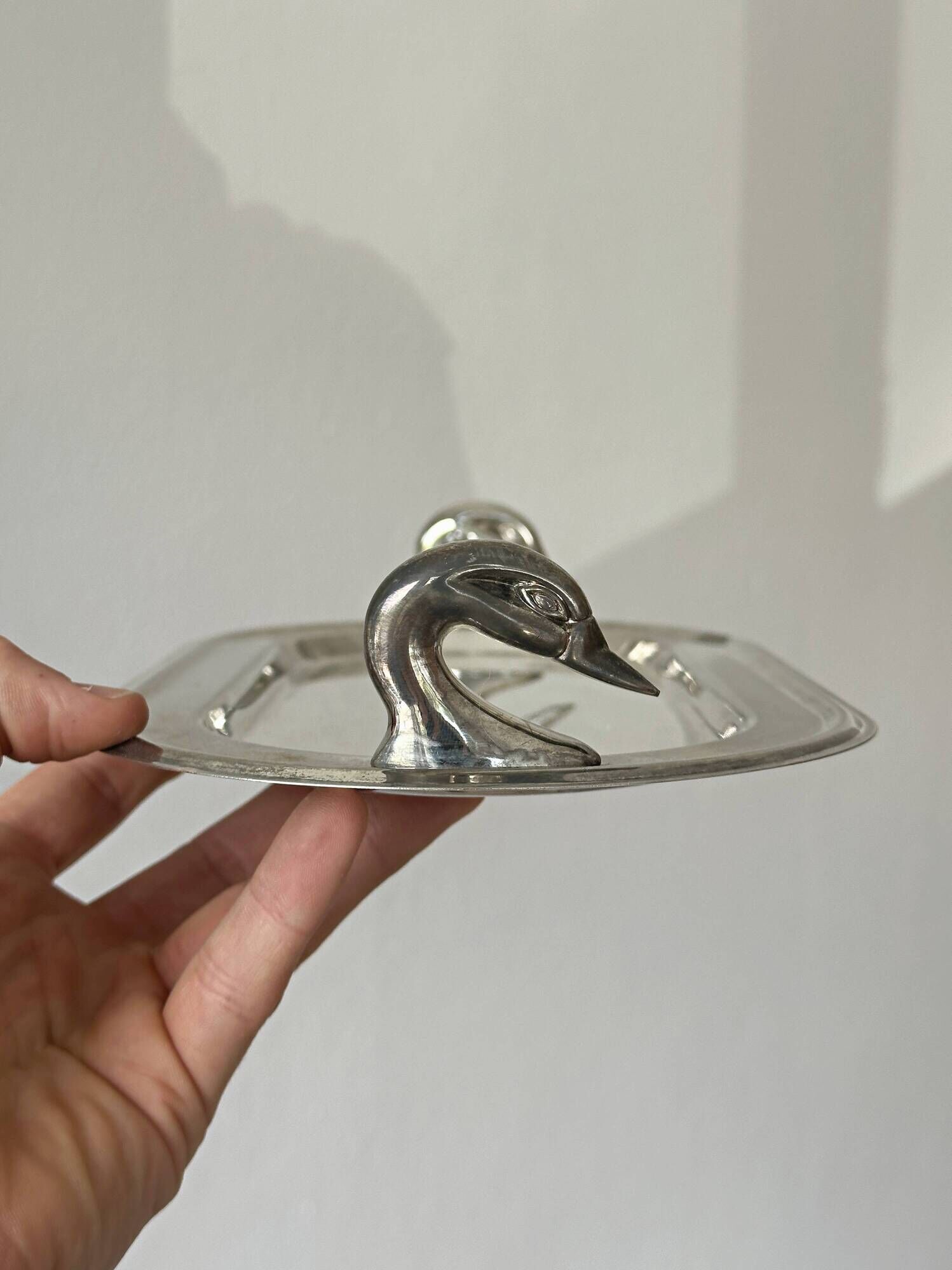 Ancient metal plateau with swans