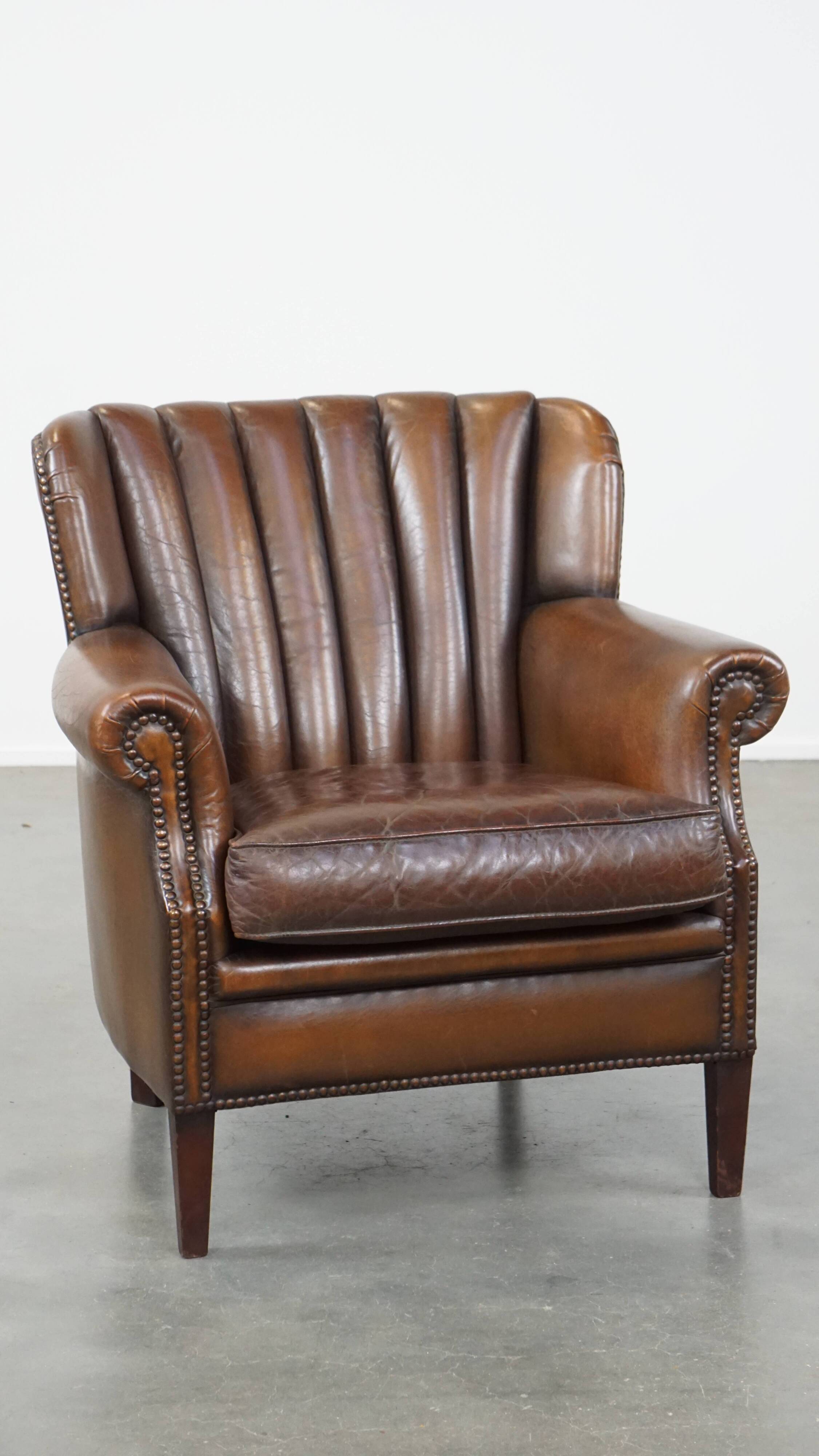 Sheep leather armchair finished with decorative nails