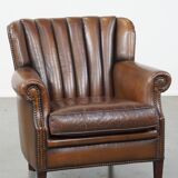 Sheep leather armchair finished with decorative nails