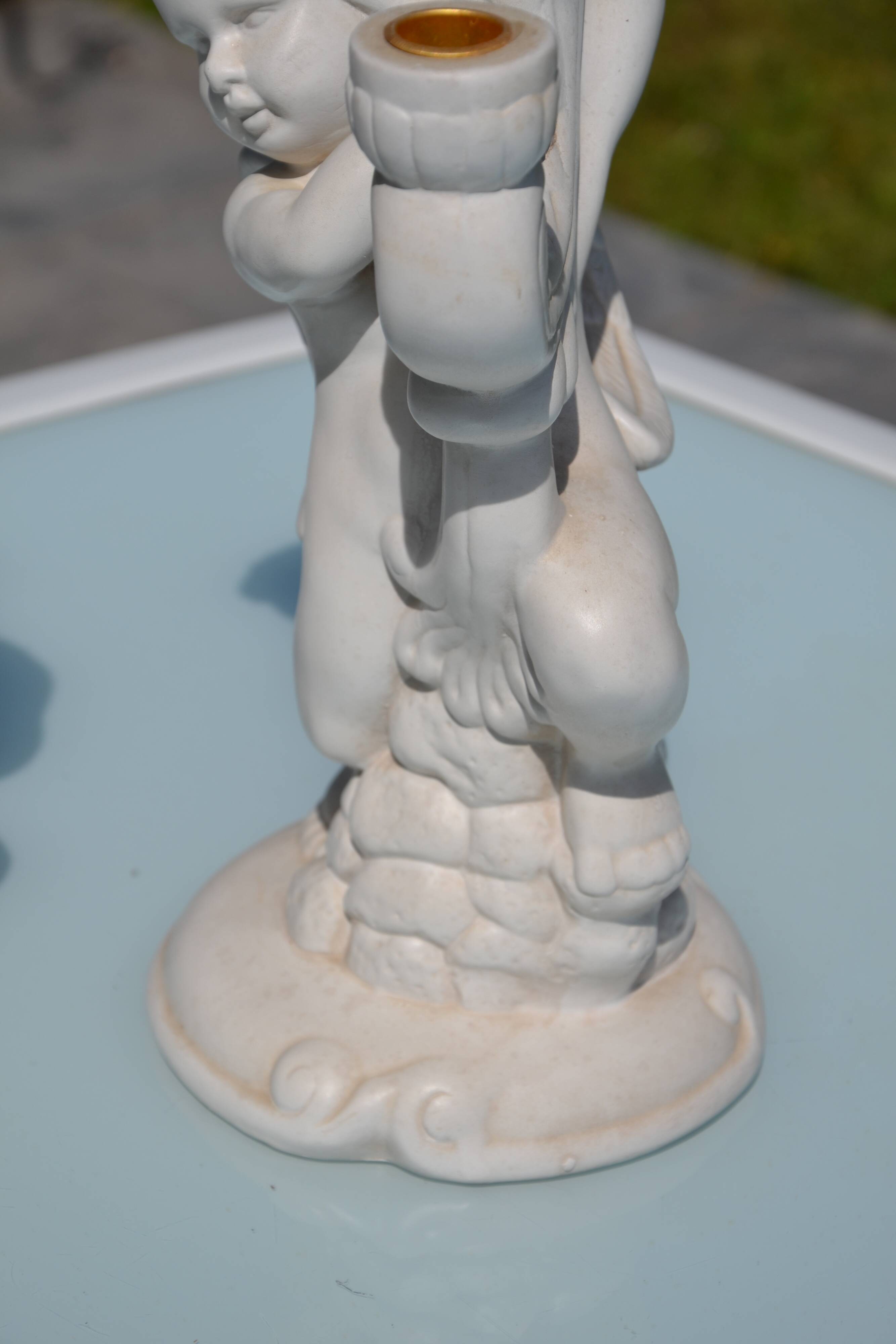 Pair of "cherub" candle holders in plaster