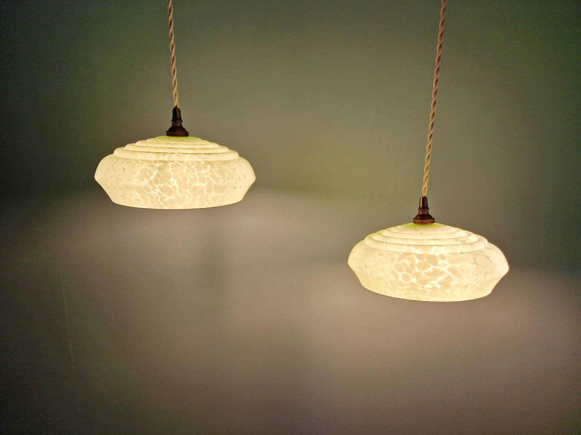 Pair of Art Deco light fixtures in light green speckled glass, 1930s.
