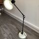 Desk lamp has two articulated metal arms
