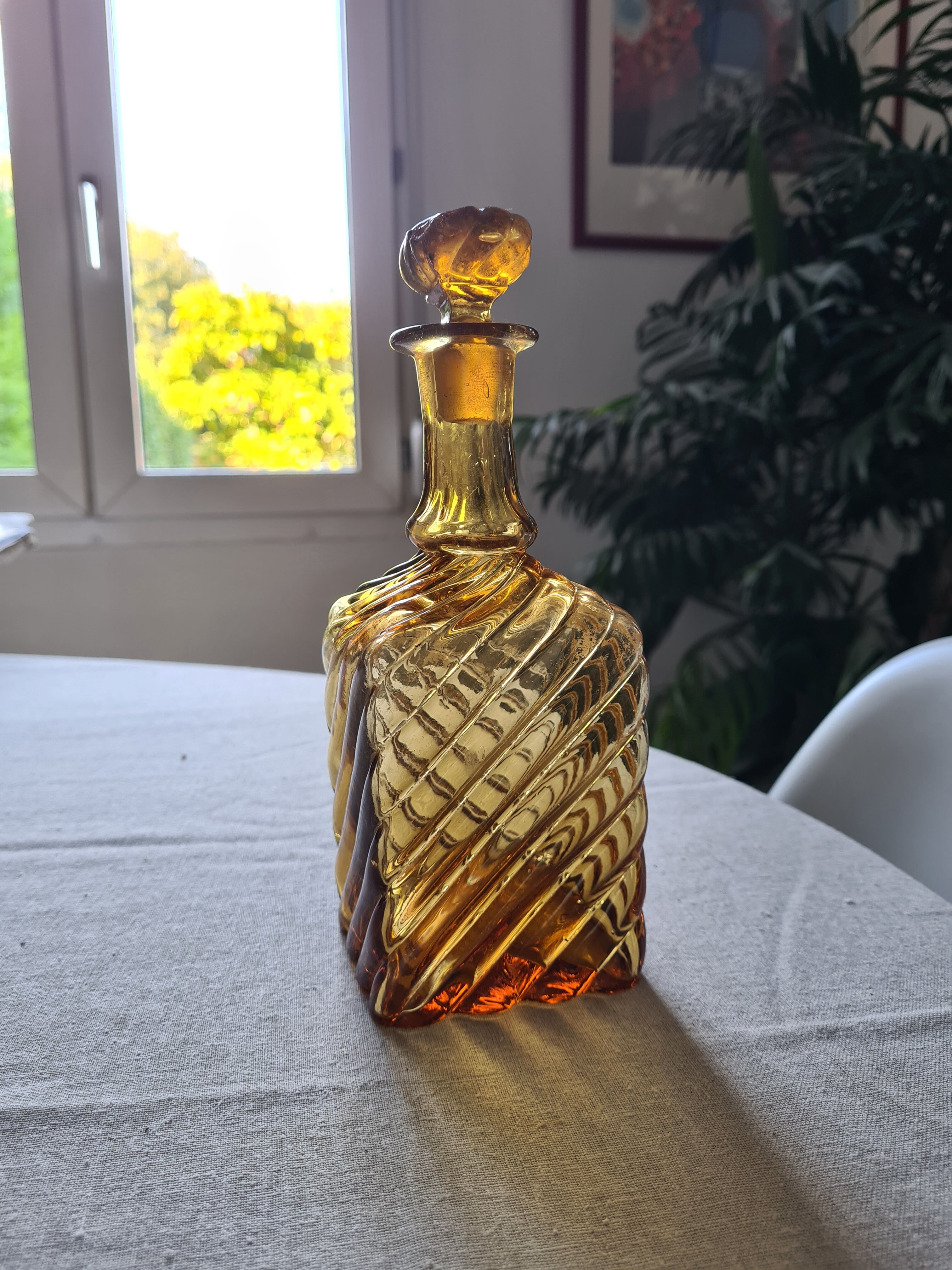 Antique decanter made of amber blown glass