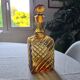 Antique decanter made of amber blown glass