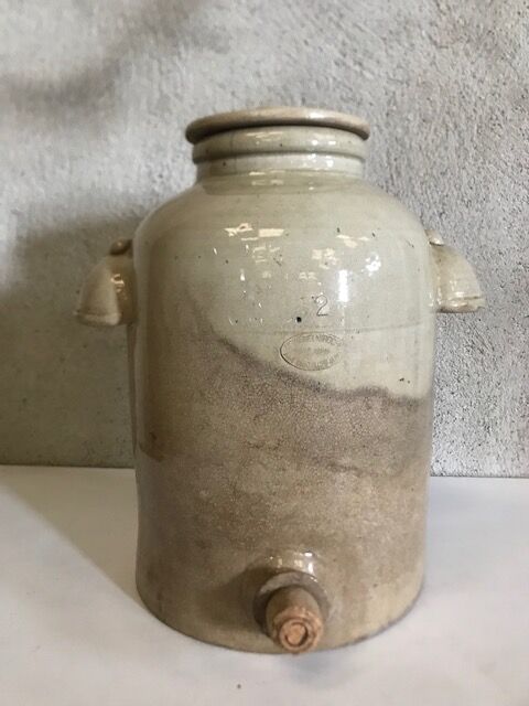 Old vinaigrier in sandstone vintage pot