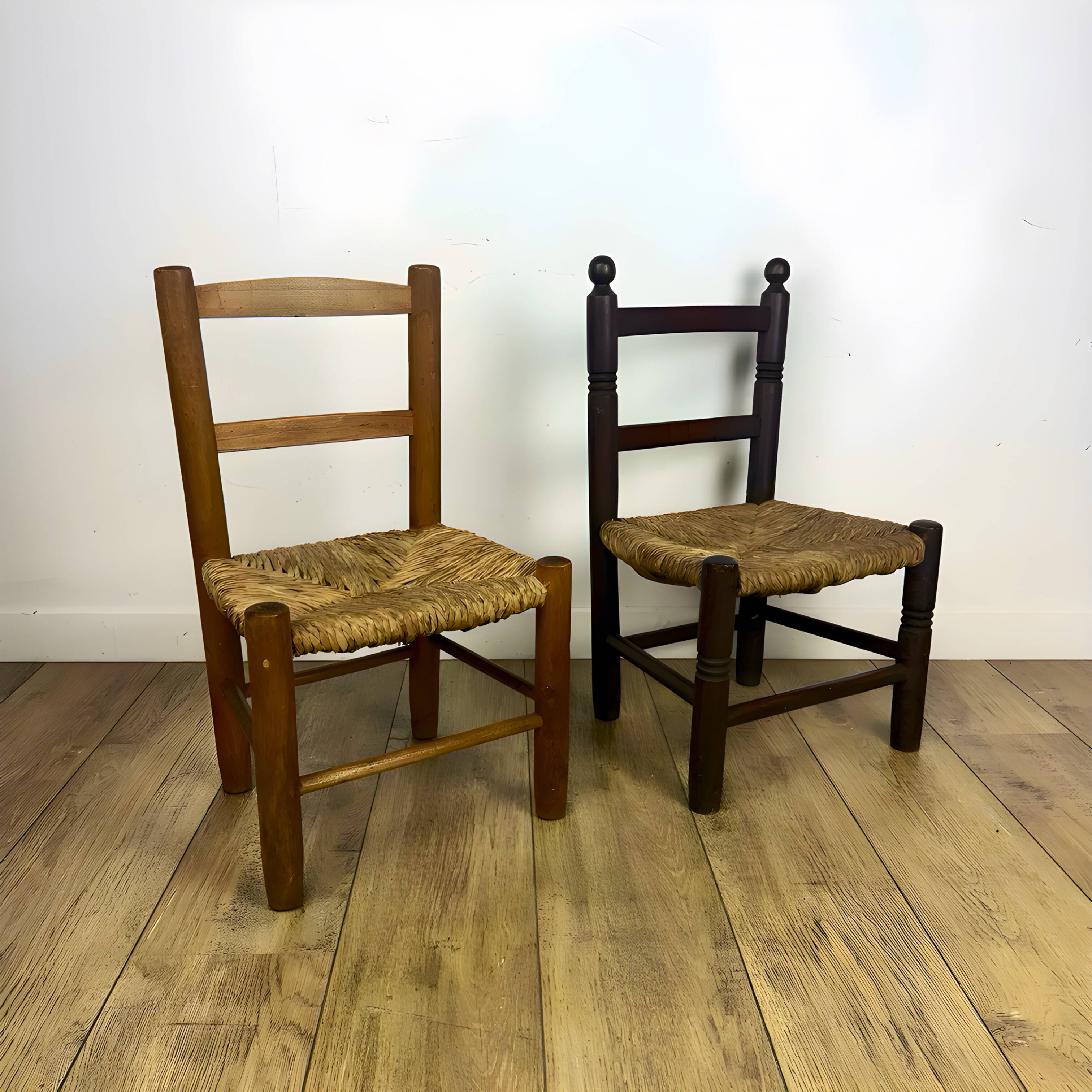 Pair of old wooden and straw children's chairs.